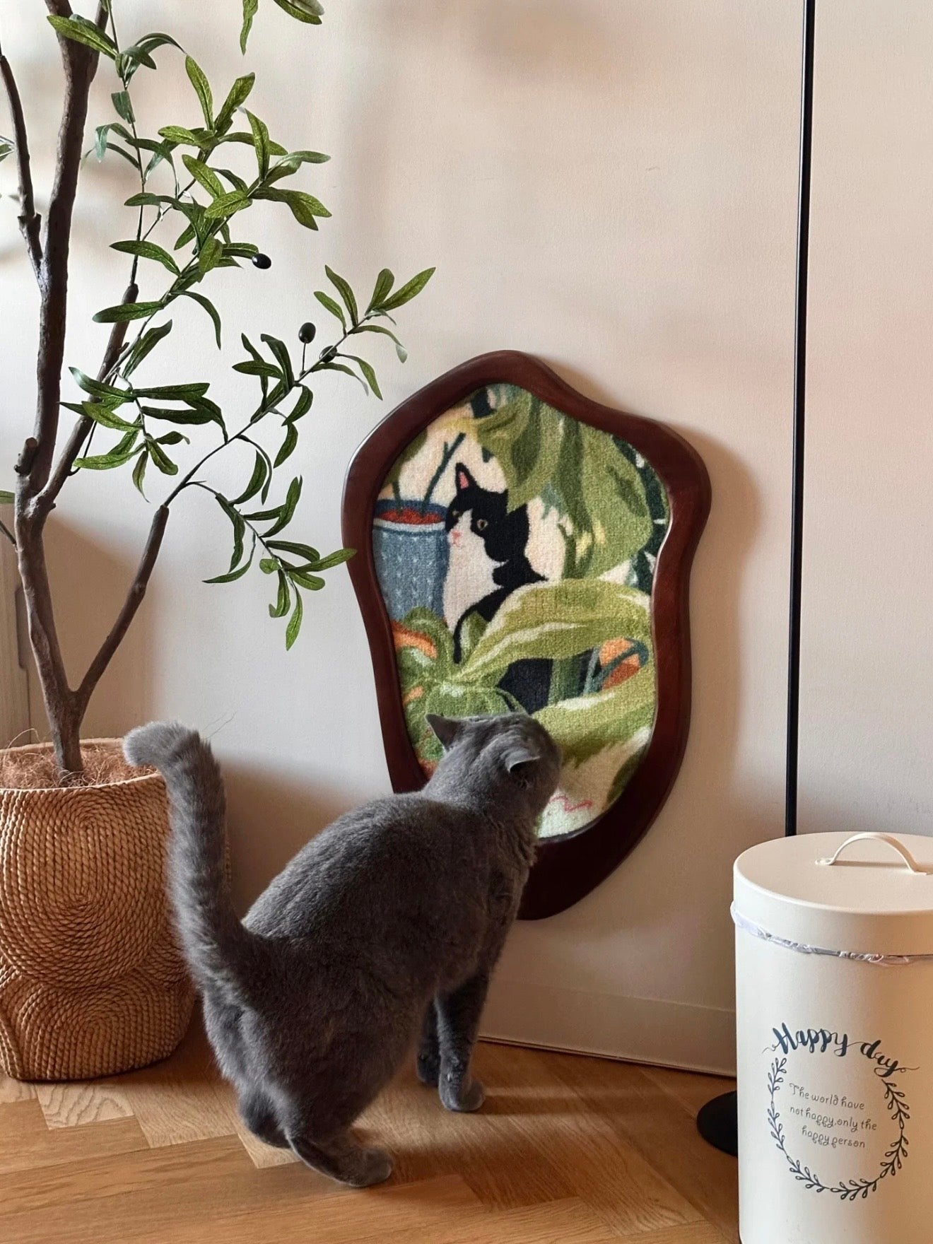 Gray cat inspecting the Cats and Plants Art Print Cat Scratcher in a real home