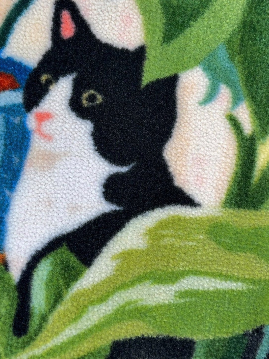 Black cat illustration on textured felt surface