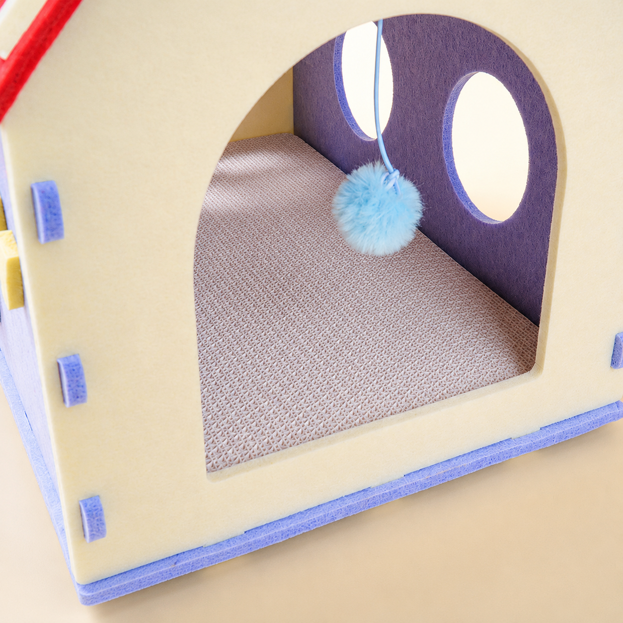 Red House Cat Cave interior scratching board and dangle toy